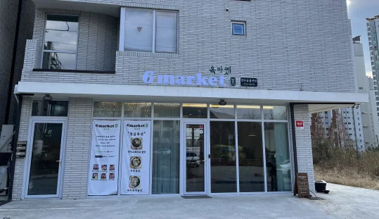 가게 앞 — 흰 벽돌 3층 건물, 1층 유리창 위 «6market» «육마켓» 간판